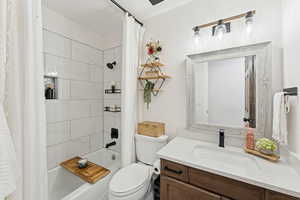 Full bath featuring shower / tub combo with curtain and vanity