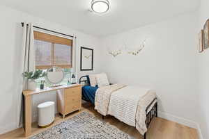 Bedroom with light wood-style floors