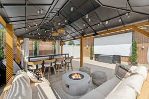 View of patio / terrace featuring a fire pit and a gazebo