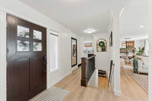 Foyer featuring light wood-style flooring, recessed lighting, and crown molding