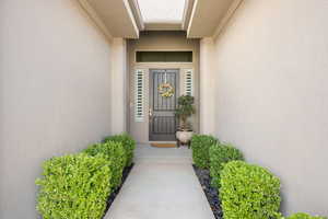 Entrance to property with stucco siding