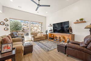 Living room with light wood-type flooring, ceiling fan, and recessed lighting