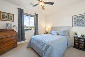 Bedroom featuring light carpet and a ceiling fan
