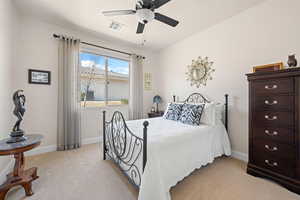 Bedroom with ceiling fan and light colored carpet