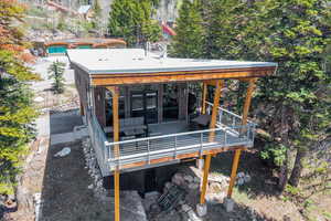 Back of property with private covered deck