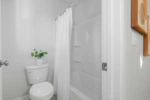 Full bathroom featuring toilet and shower / bath combo