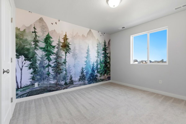 Spare room featuring light carpet and baseboards