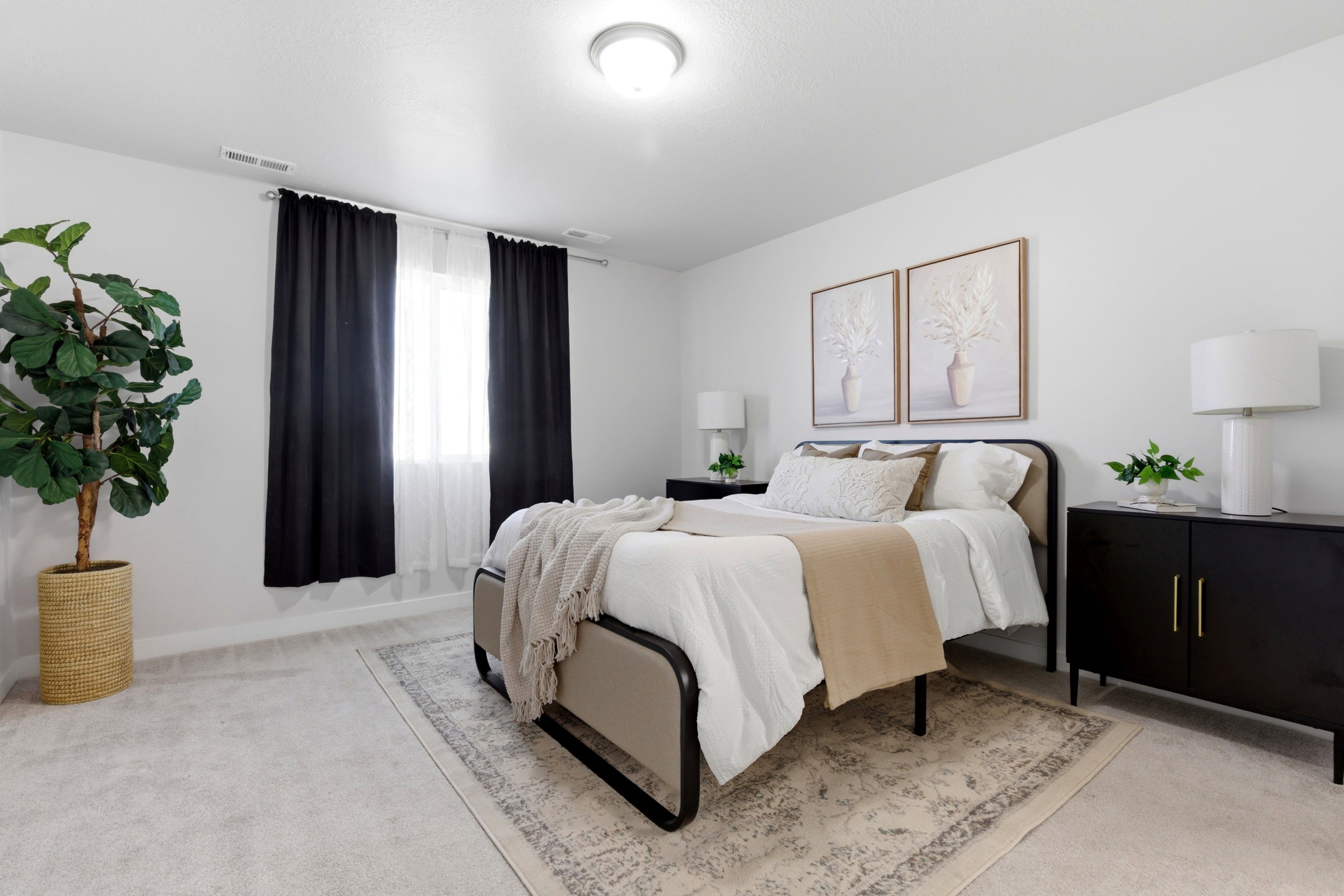 Bedroom with light carpet and baseboards