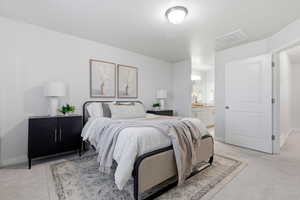 Bedroom with light colored carpet and connected bathroom