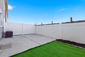 Fenced backyard with a patio