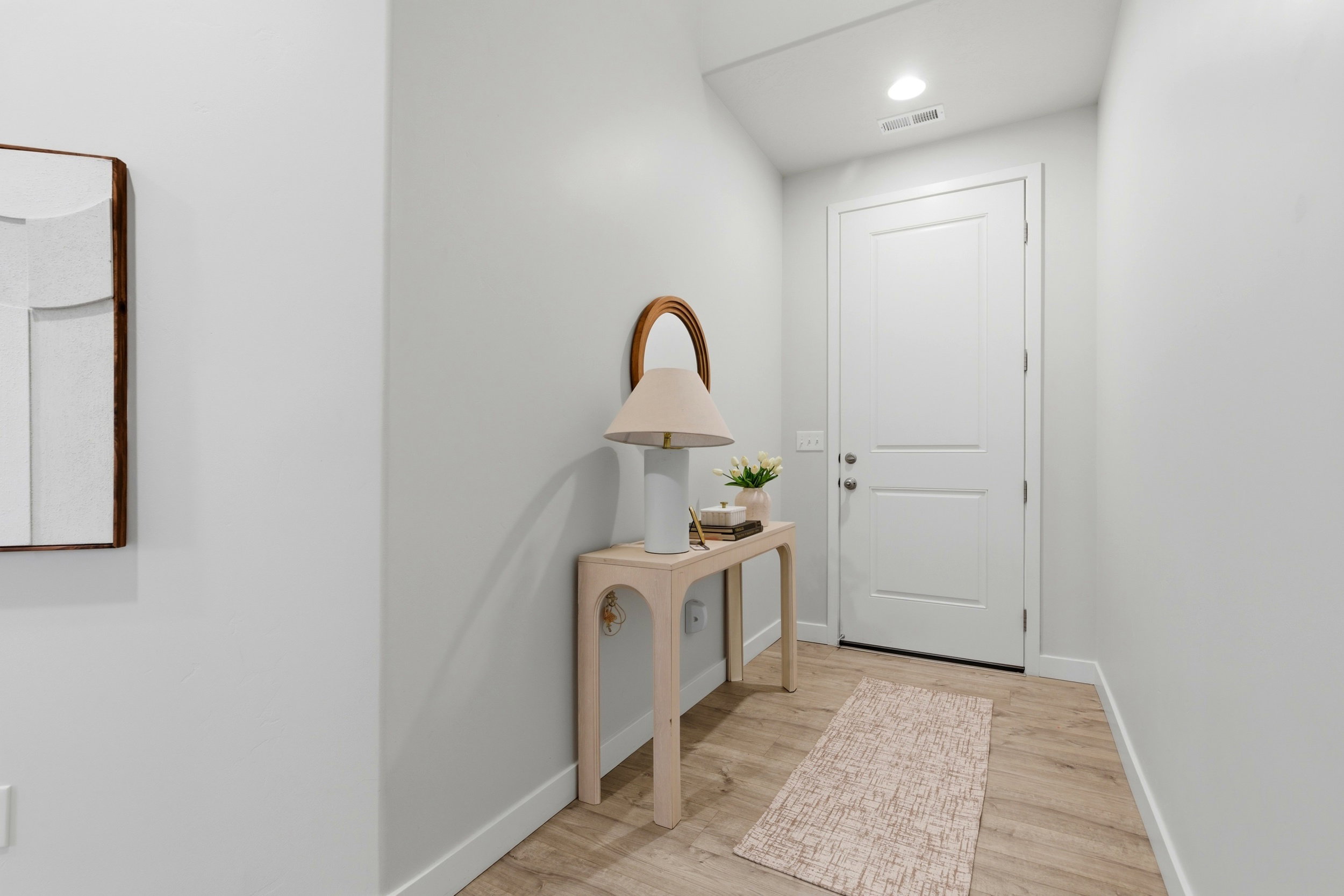 Doorway featuring wood finished floors and recessed lighting