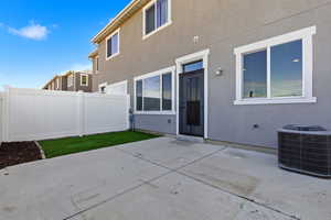 Rear view of house with a patio, stucco siding, and a fenced backyard