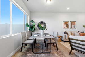 Dining area with light wood-style flooring and recessed lighting