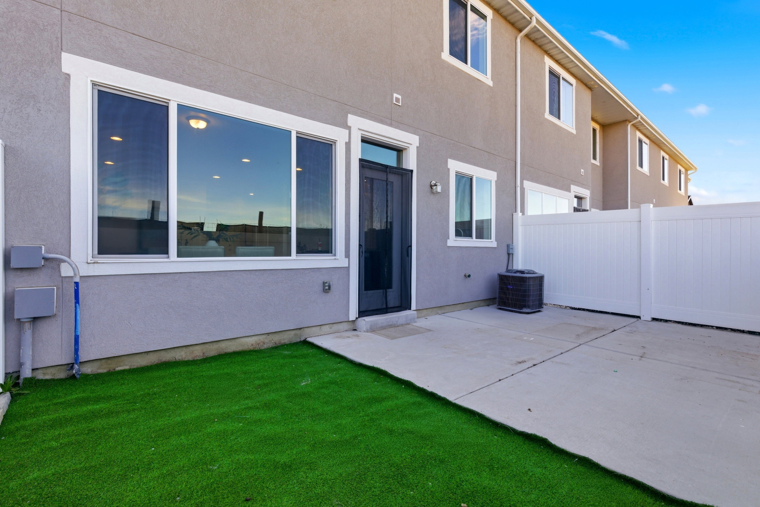 Back of property featuring a patio and stucco siding