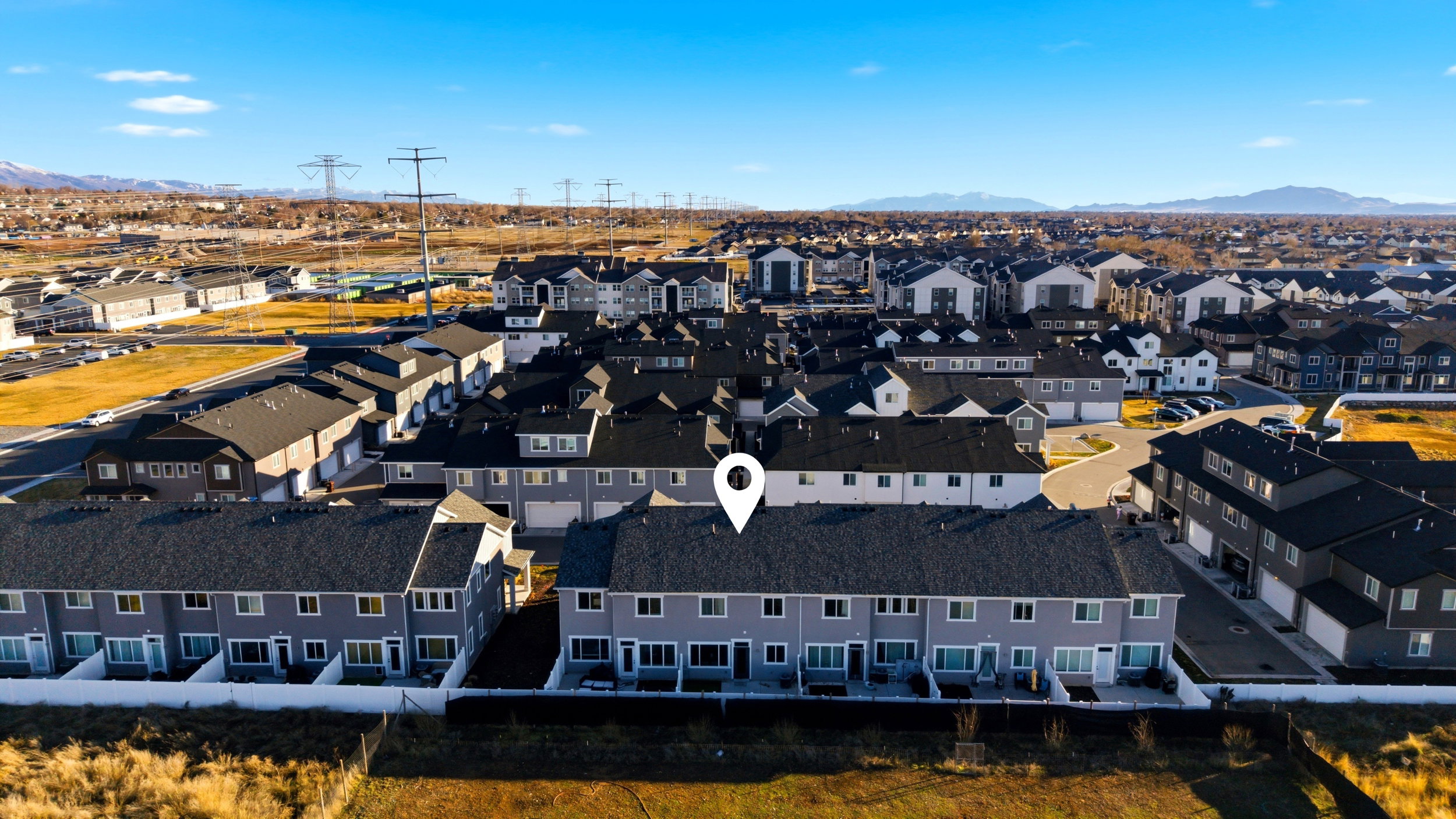 Aerial perspective of suburban area featuring a mountainous background