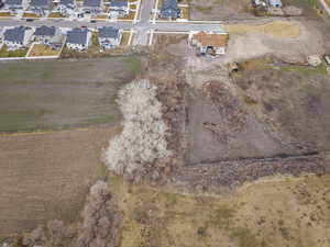 Aerial view of property and surrounding area with nearby suburban area