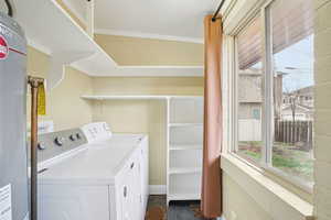 Laundry room with water heater, and washing machine and dryer
