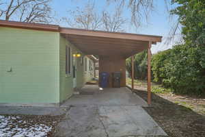 View of patio with a carport and concrete driveway