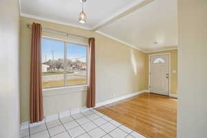 Foyer with hardwood floors, crown molding and tile floors - north unit