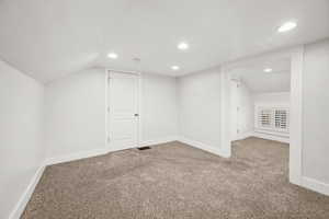 Additional living space with carpet flooring and recessed lighting