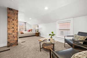 Carpeted bedroom with vaulted ceiling and recessed lighting