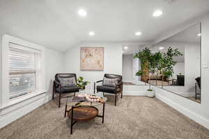 Sitting room featuring carpet floors, recessed lighting, and vaulted ceiling