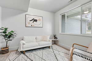 Sitting room with baseboards and carpet