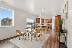 Dining room with light wood-type flooring and recessed lighting