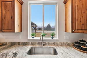 Kitchen with light stone countertops and wood finish cabinets