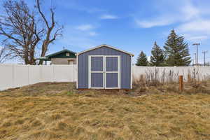 View of shed with a fenced backyard