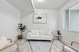 Sitting room featuring carpet flooring and baseboards