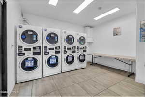 Community laundry room with stacked washer / dryer and washer and clothes dryer