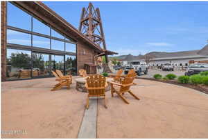 View of patio with a fire pit and a sunroom
