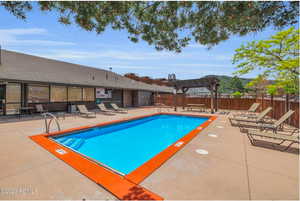 Community pool with a patio area and a pergola