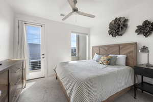 Bedroom with light carpet, access to exterior, and ceiling fan