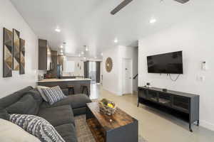 Living area featuring a ceiling fan and recessed lighting