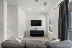 Living area featuring carpet and recessed lighting