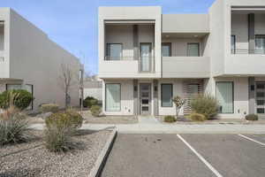 View of building exterior with uncovered parking