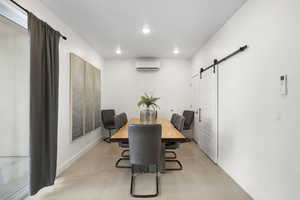 Dining room featuring a barn door and recessed lighting