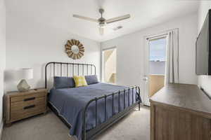 Bedroom with light colored carpet and ceiling fan