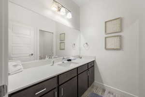 Bathroom featuring vanity and light wood finished floors