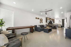 Living room featuring ceiling fan and recessed lighting