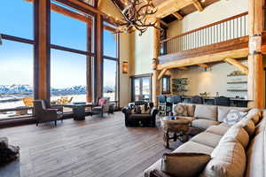 Living room with hardwood / wood-style floors, a mountain view, and hanging lights
