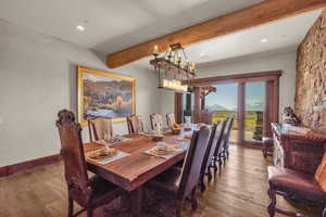 Dining space with wood-type flooring, beamed ceiling, a mountain view, and recessed lighting