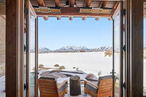 Snow covered patio featuring a mountain view