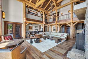 Living area featuring hardwood / wood-style floors, a chandelier, and a high wood beamed ceiling