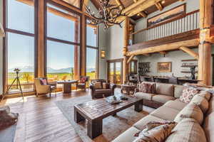 Living room with hardwood / wood-style flooring, a mountain view, and suspended lighting