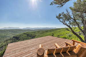 Wooden terrace featuring a mountain view