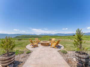 View of patio featuring an outdoor fire pit and a mountain view