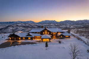 View of front of house featuring a chimney, a balcony, and a mountain view